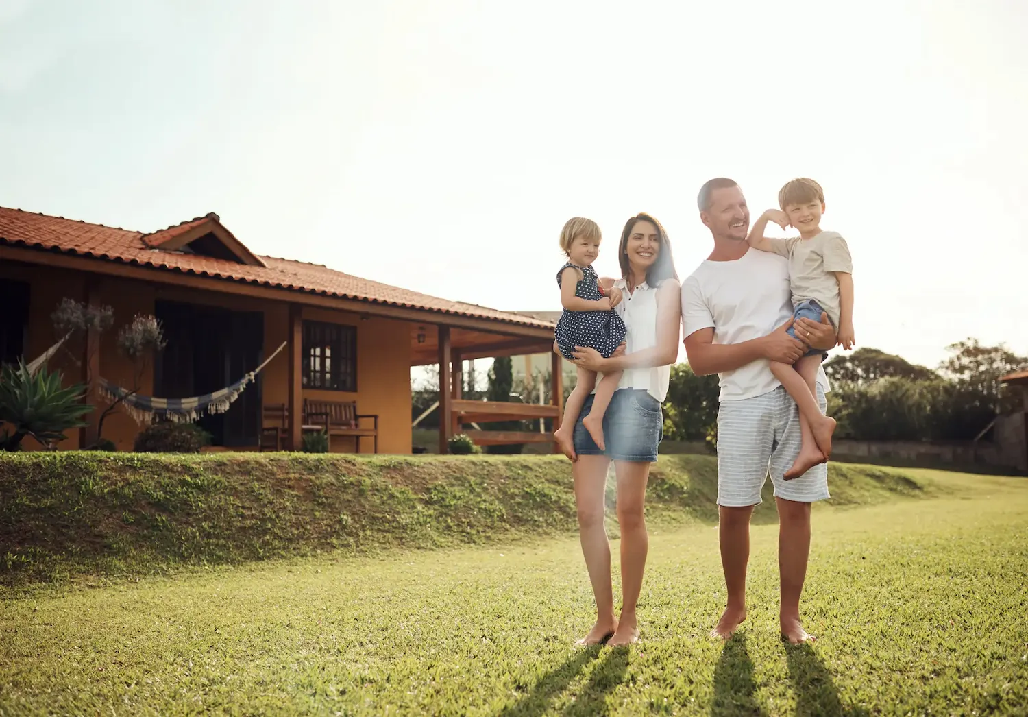 Happy family standing outside a holiday house for a relaxing family accommodation stay