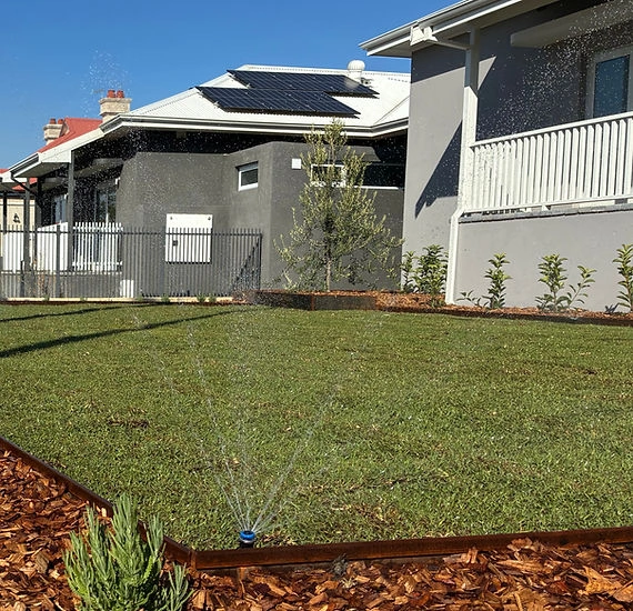 Green Slate Lawns & Retic truck and trailer parked on a freshly laid front verge lawn
