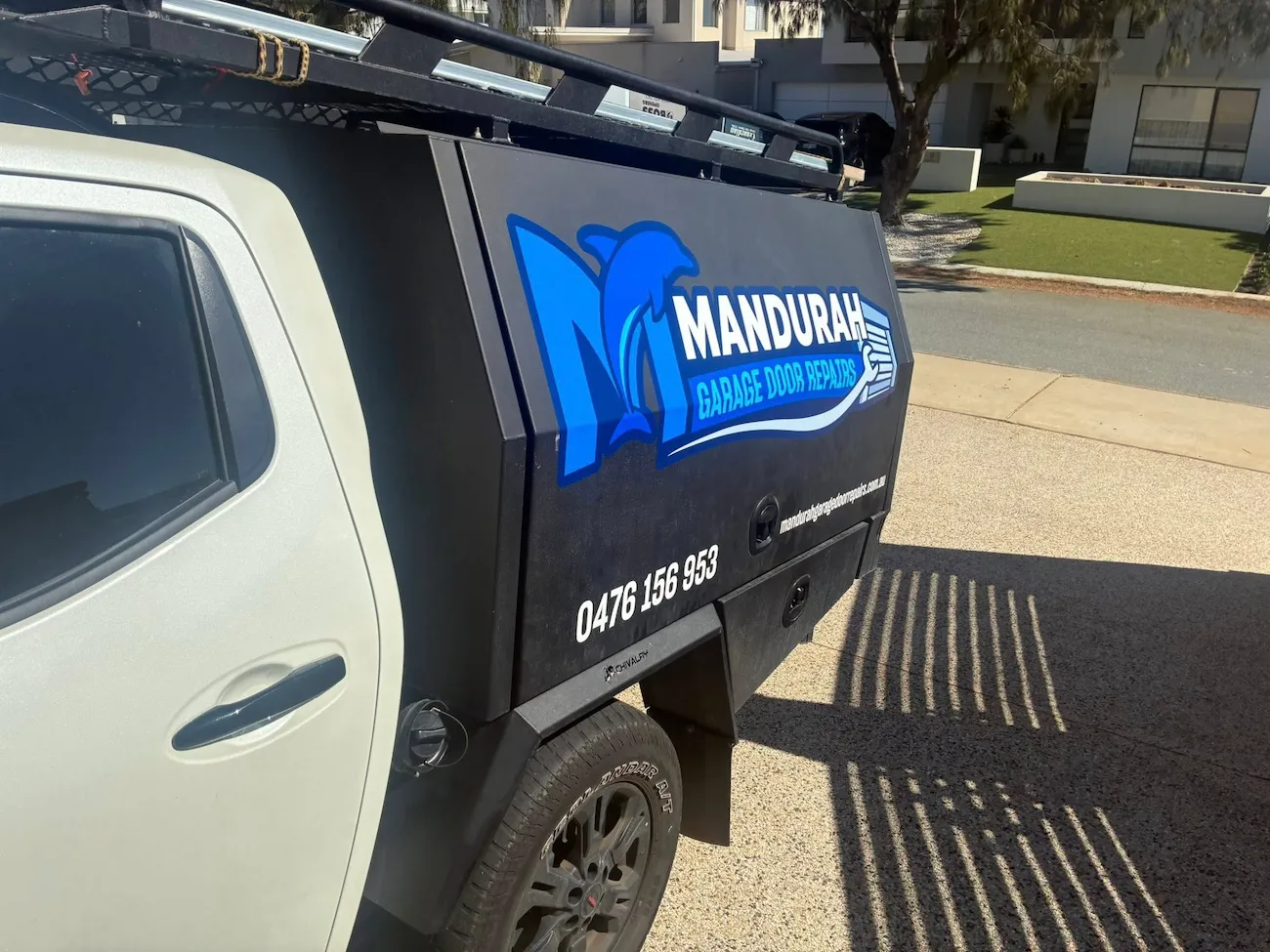 Mandurah Garage Door Repairs team member standing beside a branded service vehicle for garage door repair services