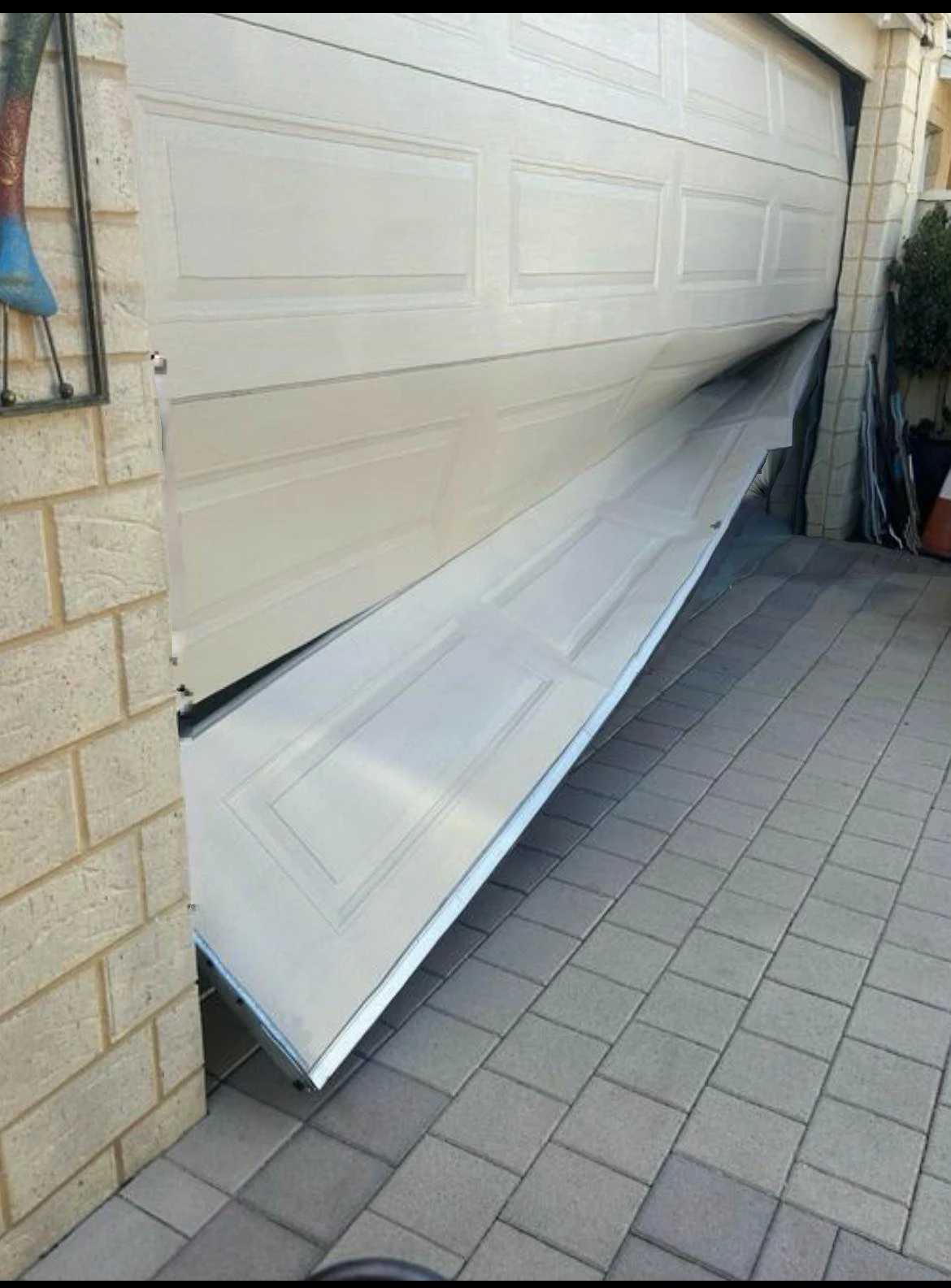 Close-up of a garage door track, roller and hinge mechanism for Mandurah Garage Door Repairs servicing