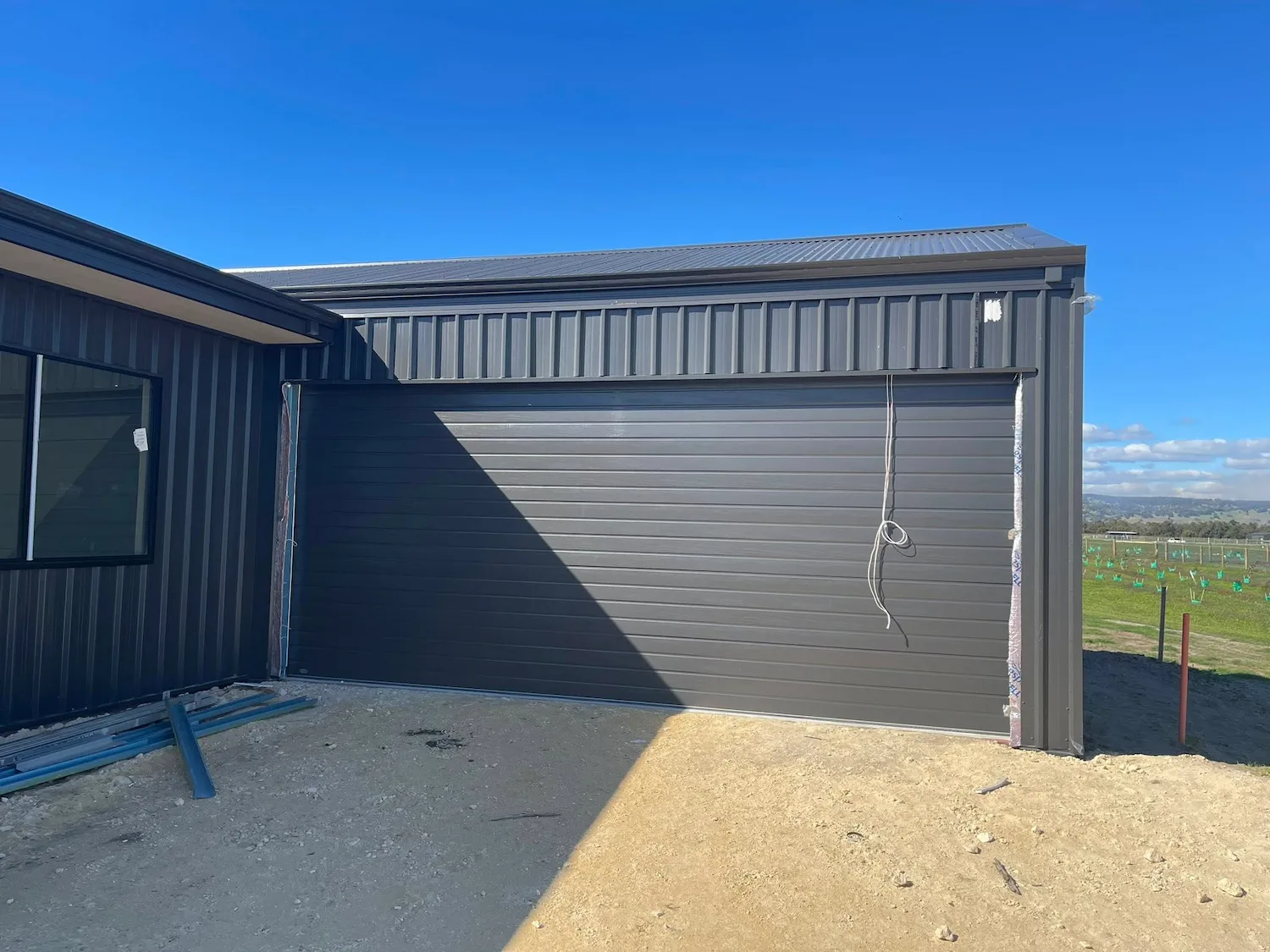 Close-up of a garage door track, roller and hinge mechanism for Mandurah Garage Door Repairs servicing