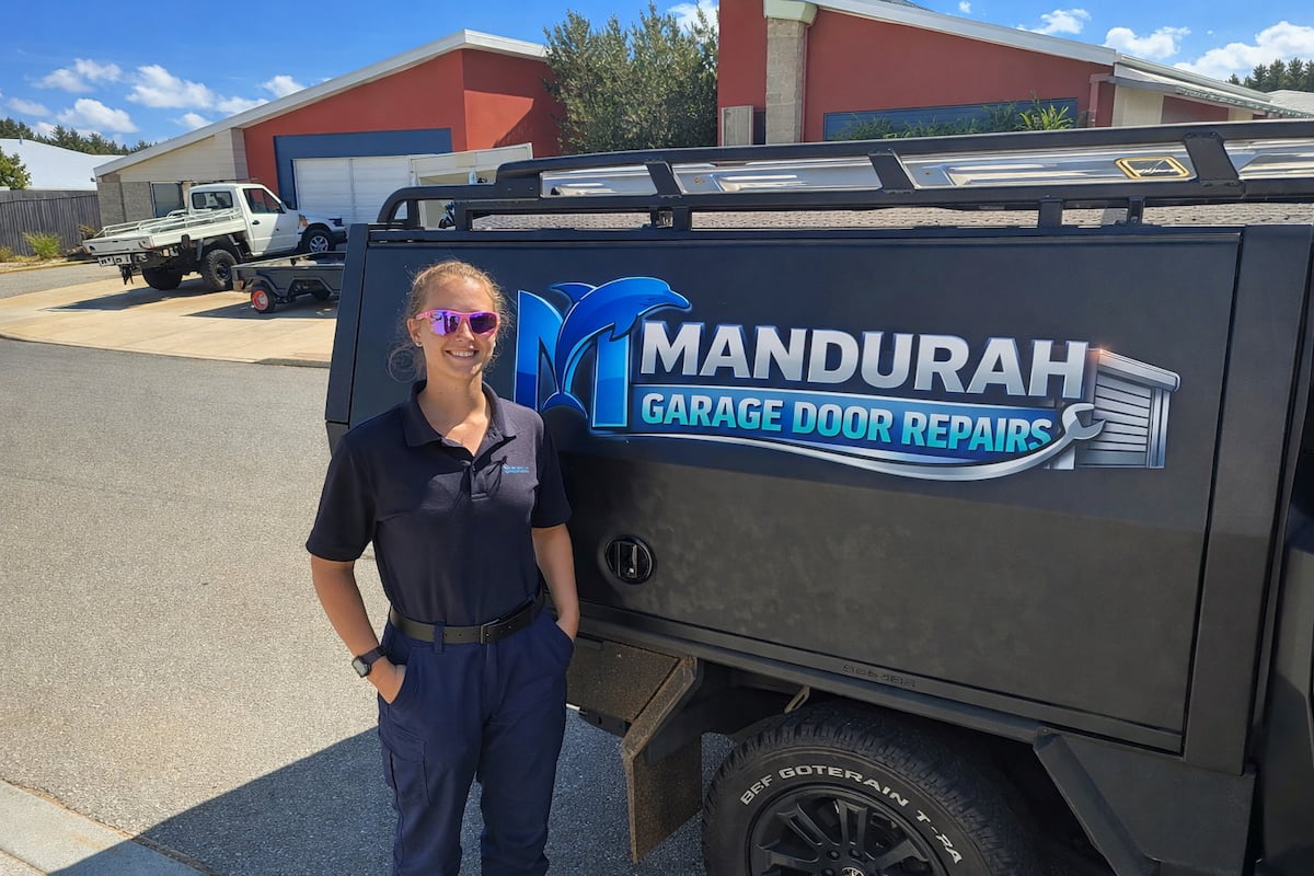 Mandurah Garage Door Repairs technician inspecting a residential roller garage door and discussing repair options with a homeowner